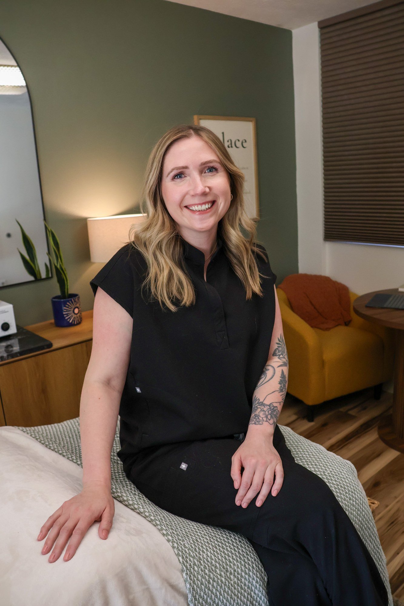 A skincare professional seated in a treatment room